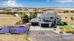 A single-story house with a garage, a basketball court, and a driveway marked with a 'D'.