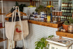 A kitchen counter with various food items and a hanging bag. - Lanai + Pool View Tropical Oasis, Plantation Hale (Kapaʻa)