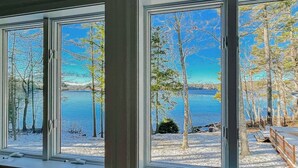 A view through a window with a lake and trees in the background. - Lakefront house on Damariscotta Lake, perfect getaway (Nobleboro)