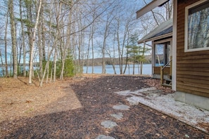 Une cabane avec vue sur un lac et des arbres.