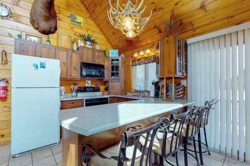 Two lakefront dog-friendly cabins on four acres with porches, dock, & lake views