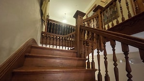 A wooden staircase with a handrail and a balustrade. - 1896 O'Malley House (New Orleans)