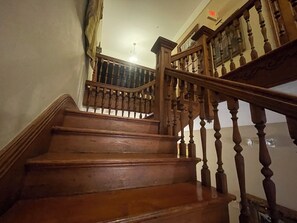 A wooden staircase with a handrail and a balustrade. - 1896 O'Malley House (New Orleans)