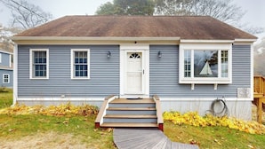 A single-story house with a front porch, a white door, and a mailbox. - Boothbay Harbor Home with Water Views | Near Dining & Whale Watching (Boothbay Harbor)