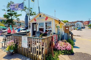 A small wooden building with a sign reading 'Harbor Master,' surrounded by a wooden fence and potted plants. - Two-story home steps from Laite Beach - stroll to the harbor, 1 dog welcome (Camden)