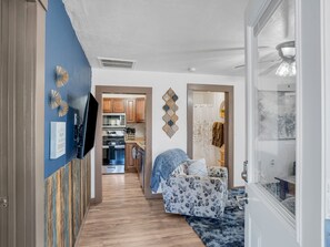A modern kitchen with wooden cabinets, a microwave, and a stove. - WALK TO EVERYTHING, REMODELED, BEAUTIFUL NEIGHBORHOOD, LARGE YARD, AND FENCED! (Williams)
