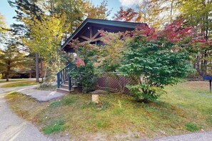 A house with a covered porch, a staircase, and a mailbox. - Create memories in this dog-friendly cabin w/fireplace, AC & near hiking (Northport)