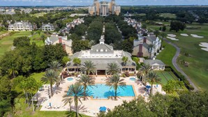 A large resort with a central pool, multiple guest villas, and a golf course. - Brand New | 6BR Reunion Pool & Spa Villa 7894 (Kissimmee)