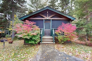 A lodge with a wooden exterior, a front door, and a porch. - Comfortable dog-friendly cabin with fireplace & kitchenette near hiking trails (Northport)