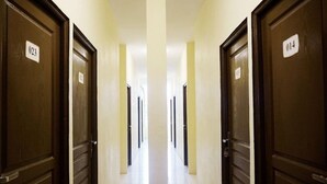A hotel hallway with doors numbered 023 and 014. - Lotus Inn (Pekanbaru)