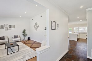 A modern living room with a sofa, coffee table, and decorative wall art.