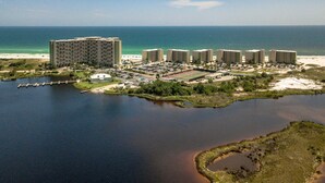 A coastal hotel with multiple high-rise buildings, a marina, and a beach. - Pinnacle Paradise 336-Gulf Views-Sleeps 7 (Panama City Beach)