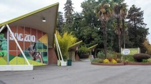 A building with a large mural advertising an event, surrounded by trees and a clear sky. - Prime 2BR Upstairs Unit in the heart of Sacramento (Sacramento)