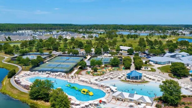 A resort with multiple swimming pools, tennis courts, and a large building likely for events or dining. - Private Resort Retreat Near Rehoboth Beach in Exclusive "The Peninsula" (Millsboro)