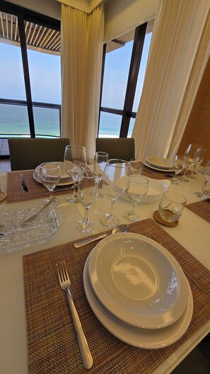 A table set for dining with a view of the ocean. - Vieira Souto 500: Luxury Oceanfront Sanctuary with Panoramic Views in Ipanema (Rio de Janeiro)