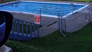A swimming pool with a view of a town in the background.