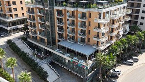 A multi-story hotel with balconies, a rooftop bar, and a ground-level spa area. - 308A, Diamond Two Bedroom Apartment, Vlore, Albania (Vlore)
