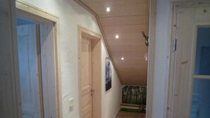 A hallway with wooden doors, a wooden floor, and a ceiling with recessed lighting. - Oberm Dorp in Winterberg-Hildfeld by Interhome (Winterberg)