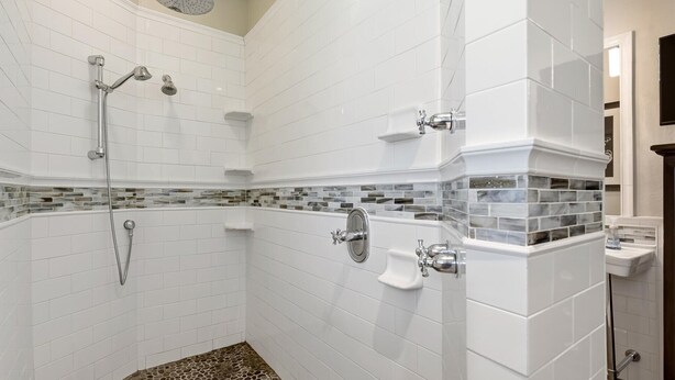 A shower with multiple heads, a tiled floor, and a corner sink. - Welcome to Your Private Slice of Paradise on Beautiful Marco Island! (Marco Island)