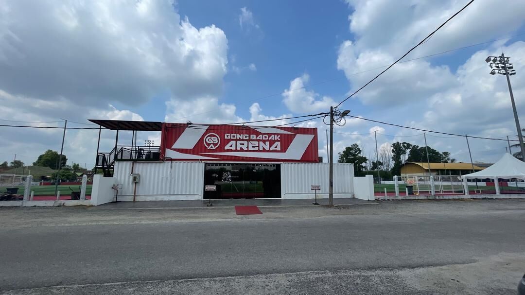 A large building with a prominent sign reading 'GONG BADAK ARENA.'