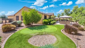 A house with a well-maintained lawn, a patio area, and a small garden. - 5 Min to Stadium • Putting Green + BBQ (Glendale)