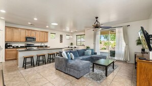 A spacious living area with a sofa, coffee table, and kitchen area with wooden cabinets and a microwave. - 5 Min to Stadium • Putting Green + BBQ (Glendale)
