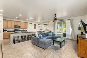 A spacious living area with a sofa, coffee table, and kitchen area with wooden cabinets and a microwave. - 5 Min to Stadium • Putting Green + BBQ (Glendale)