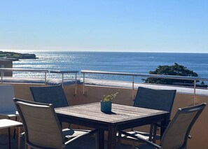 A balcony with a table and chairs, overlooking a coastal view. - Art Deco Coastal Retreat, 250m to Coogee Beach (Coogee)