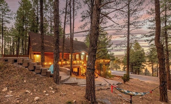 A cabin with a porch, surrounded by trees, and a hammock. - Cozy 3-bedroom cabin in perfect Flagstaff. Wrap around porch and beautiful views (Flagstaff)