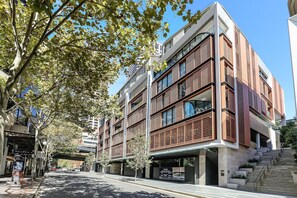 A multi-story building with a modern architectural design, featuring balconies and large windows. - 2BR by Circular Quay | The Rocks + Free Parking (The Rocks)