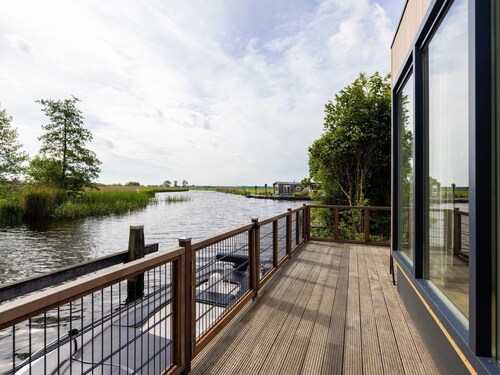 Modern chalet by the water with a sloop