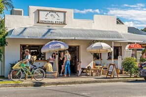 A building with a sign reading 'The Byron Bay General Store' and a bicycle parked outside.