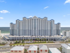 A large hotel with multiple floors, a parking garage, and a beach view. - NEW LISTING!!! Lighthouse #418 Gulf Front w/HUGE Corner Balcony! (Gulf Shores)