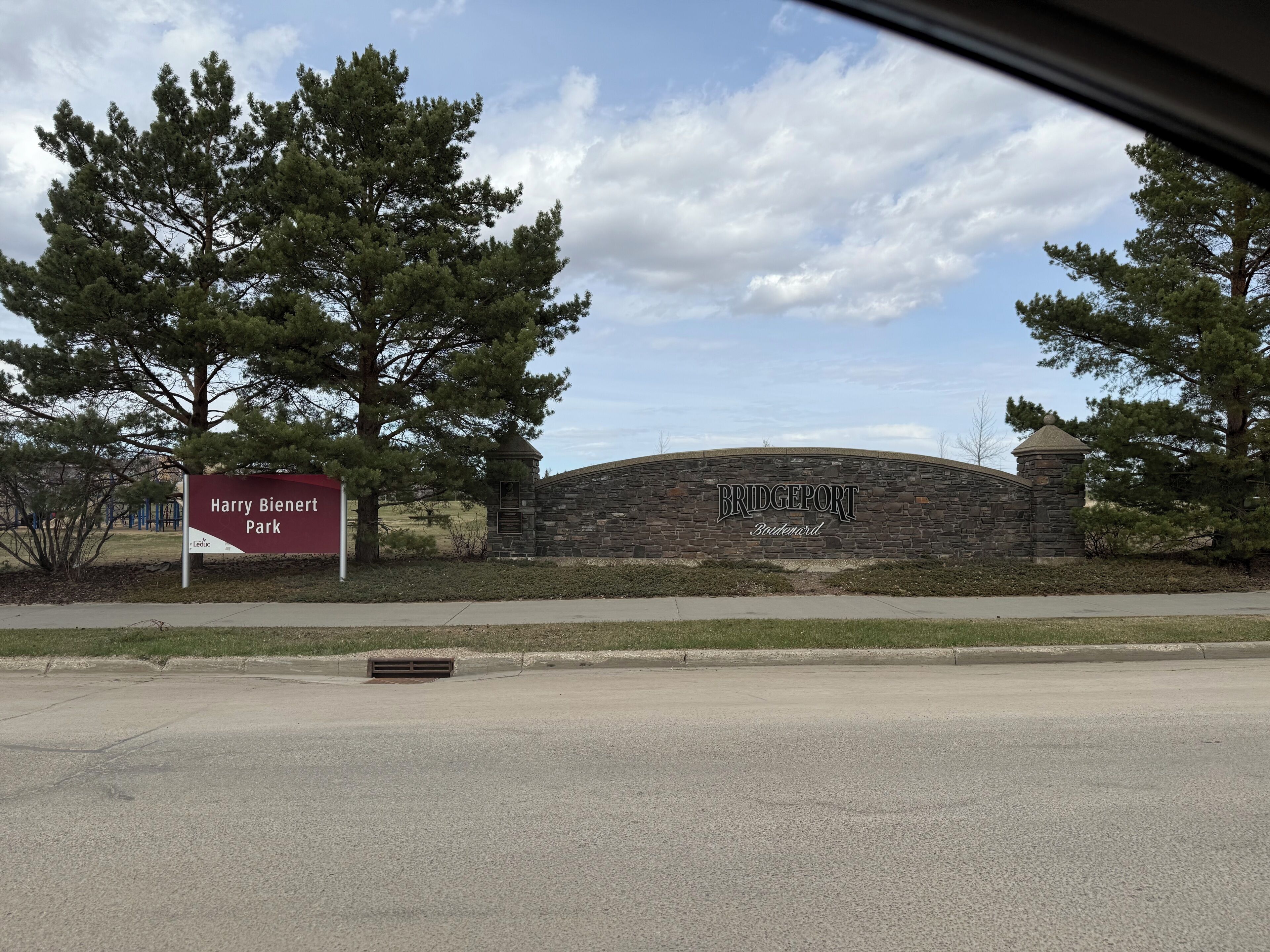Un mur de pierres sur lequel on peut lire « Bridgeport Boulevard », entouré d’arbres et sous un ciel dégagé.