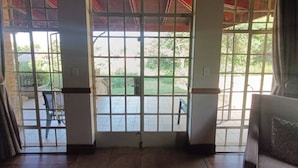 A room with a large sliding glass door leading to an outdoor patio area.