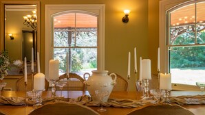 A dining table set with candles, glassware, and a vase. - Woodman Estate by Property Mums (Moorooduc)