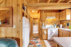 A wooden cabin interior with a kitchen, a refrigerator, a stove, and a laundry area. - 2 Mi to Blue Ridge Pkwy! Mtn Escape w/ Fireplace (Meadows of Dan)