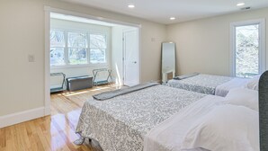 A hotel room with two beds, a large window, a radiator, and a door leading to an outdoor area. - 2 Mi to Nantasket Beach! Group Retreat w/ Patio (Hull)