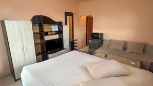 A hotel room with a bed, a TV, a desk, and a sofa. - Large Double Room in Hotel Darling Bankya (Bankya)