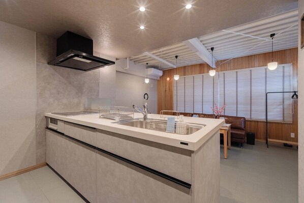 A modern kitchen with a central island, built-in oven, and pendant lighting. - Fully renovated in 2025 Entire building for rent / Edogawa Ward Tokyo (Edogawa Ward)
