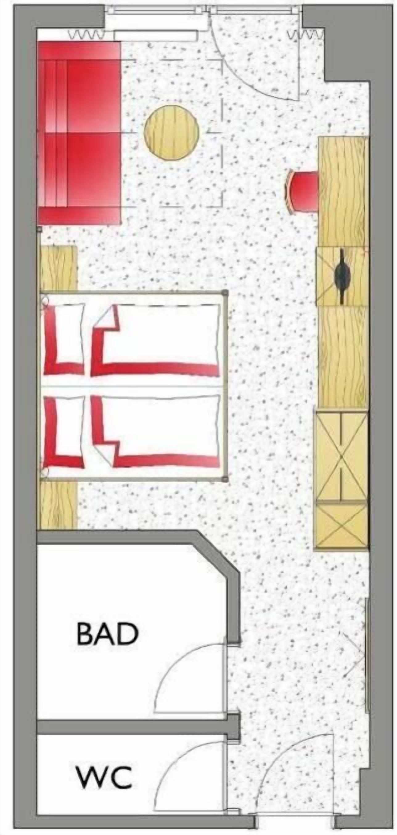A floor plan with a kitchen, dining area, and two bedrooms labeled 'BAD' and 'WC'.