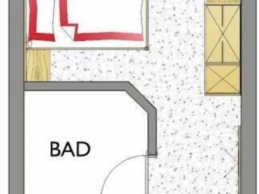 Plano de planta que muestra una cocina, comedor y dos habitaciones, identificadas como 'BAD' y 'WC'.