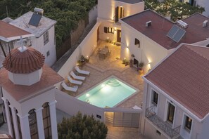 A multi-story building with a rooftop pool, outdoor seating area, and a covered patio. - Casa di Vangelis, Summer Village Stay! (Rethymno)