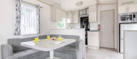 A compact kitchen with a microwave, stove, and cabinets.
