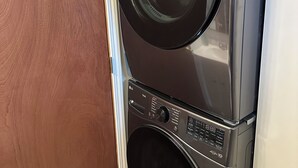 A stacked washer and dryer unit with a control panel and a door.