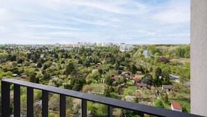 A balcony with a view of a residential area, including houses and a distant cityscape. - Lumina apart near the Visla embankment (Warszawa)