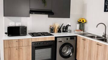 A modern kitchen with a built-in oven, microwave, stove, and dishwasher.