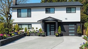 A two-story house with a garage, a front entrance, and a driveway. - Fully Furnished House, Delta, BC, Canada, (Delta)