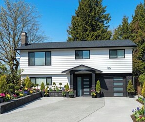 A two-story house with a garage, a front entrance, and a driveway. - Fully Furnished House, Delta, BC, Canada, (Delta)