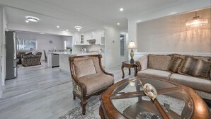 A spacious living area with a sofa, armchair, and coffee table. - Fully Furnished House, Delta, BC, Canada, (Delta)